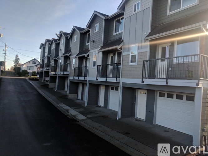 A row of townhouses with balconies and garages.