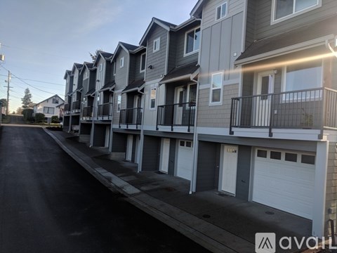 A row of townhouses with balconies and garages.