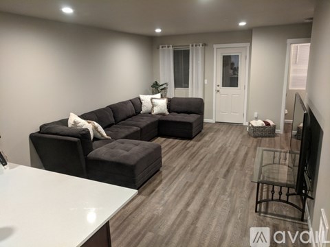 A modern living room with a large sectional sofa and a flat-screen TV.