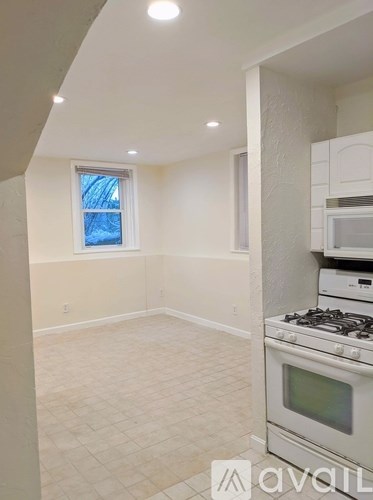 A kitchen with a stove and a window.