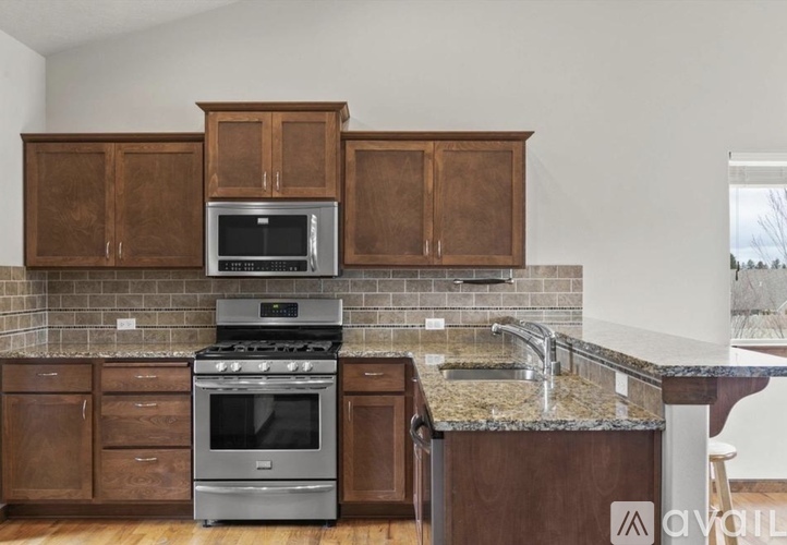 A kitchen with a stove, oven, and cabinets.