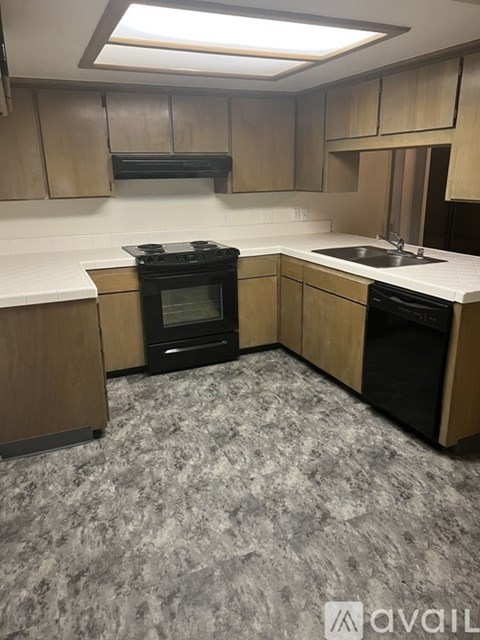 A kitchen with a black oven and sink.