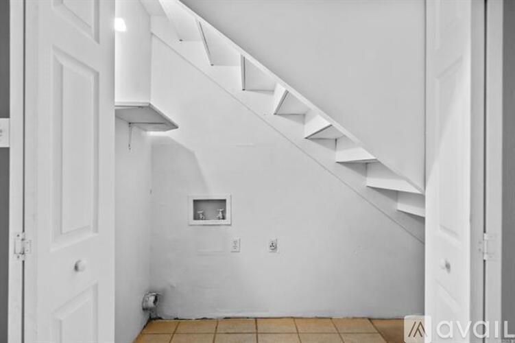 A staircase with a landing and a door on the left.