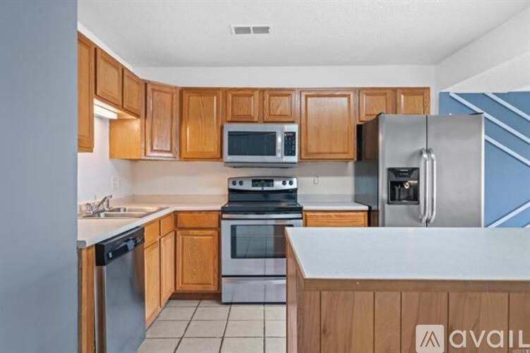 A kitchen with wooden cabinets and a white counter.
