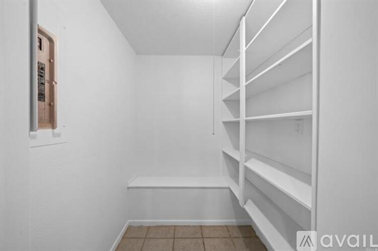 A white bunk bed in a small room.