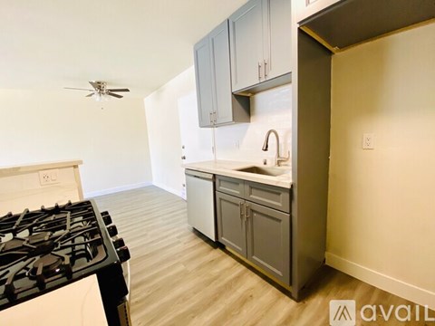 A kitchen with a black stove top and a white oven.