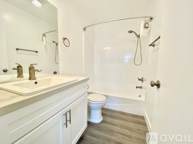 A bathroom with a toilet, sink, and bathtub.