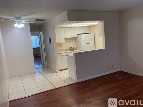 A kitchen area with white cabinets and a countertop.