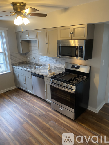 A kitchen with a stove top oven and a microwave above the stove.