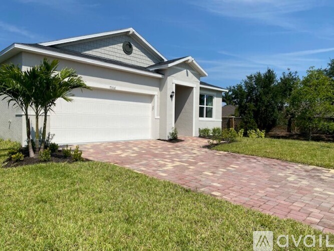 A house with a driveway in front of it.