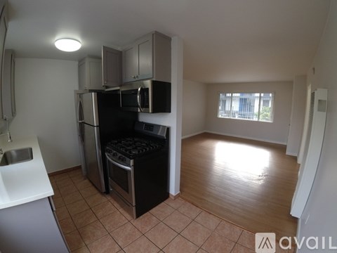 A kitchen with a black stove top oven and microwave.