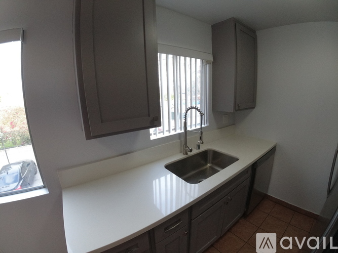 A kitchen with a sink and cabinets.