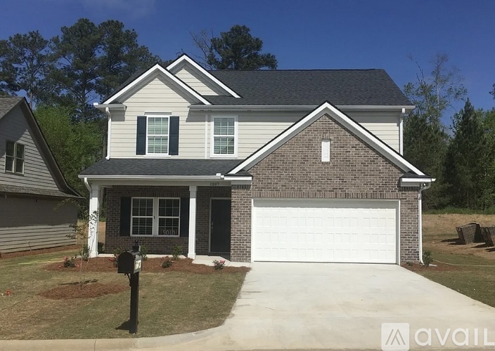 A house with a grey roof and a white garage door.