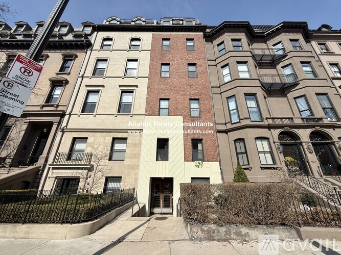 A building with a sign that says "Atlantic Real Estate Consultants" in front of it.