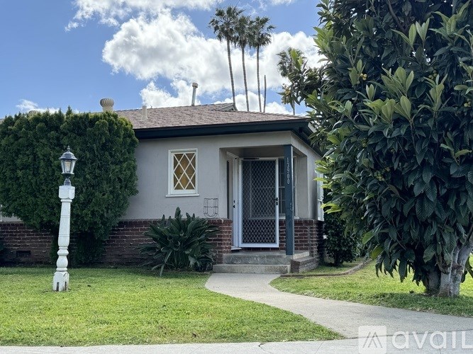A house with a white lamp post in front of it.