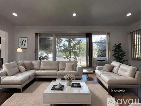 A modern living room with a large sectional sofa and a coffee table in the center.