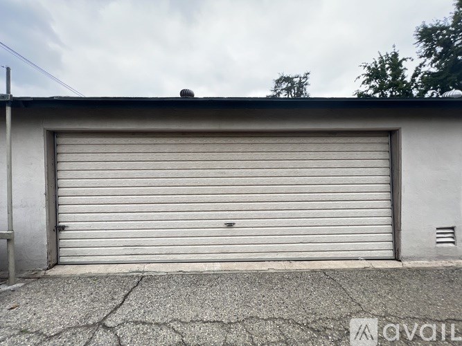 A garage door is closed and appears to be made of metal.