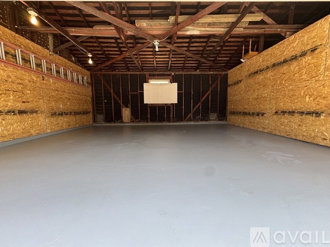 A kitchen with a ceiling fan and brown tiled floors.