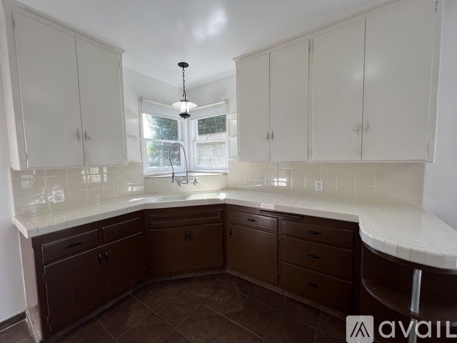 A kitchen with brown cabinets and a white countertop.