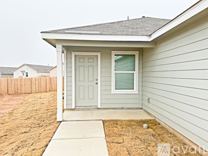 A house with a grey door and a grey wall.