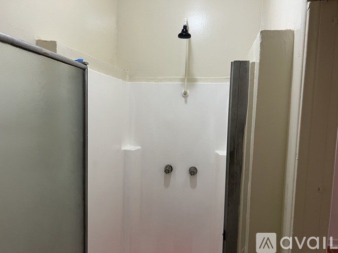 A white wall with a black light hanging from it.