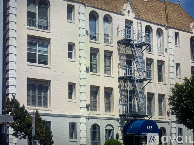 A white building with a blue sign that says 665.
