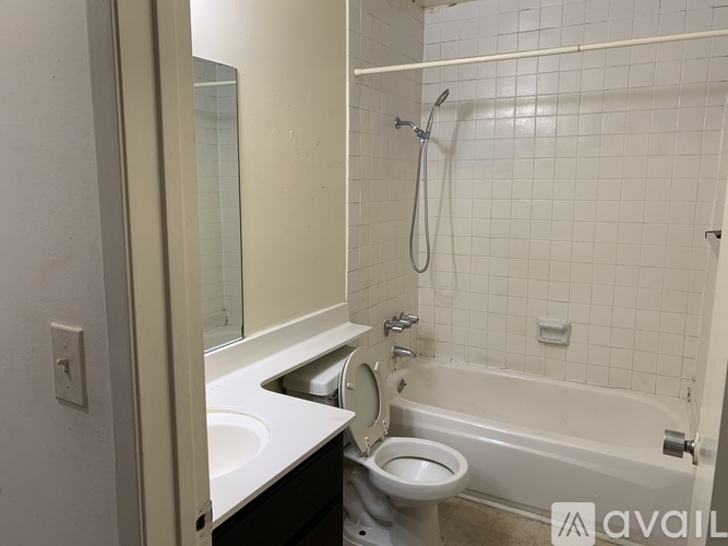 A bathroom with a toilet, sink, and bathtub.
