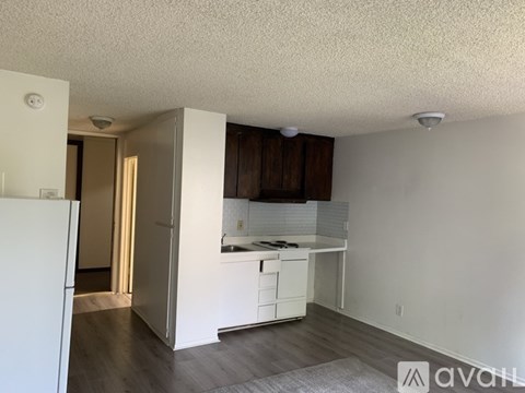 A kitchen area with white cabinets and a countertop.
