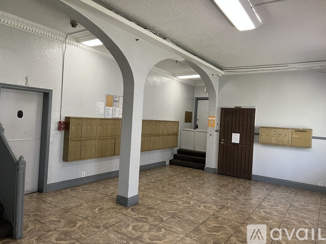 A room with a white wall and a brown door.
