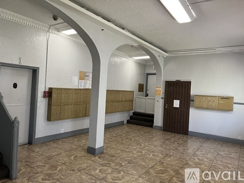 A room with a white wall and a brown door.