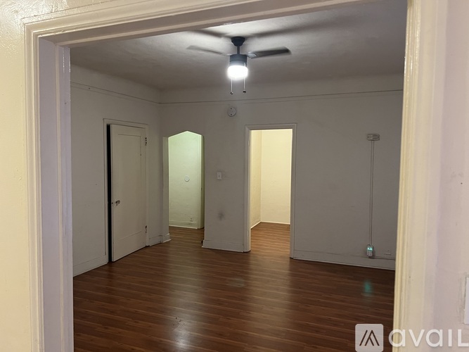 A room with wooden floors and a ceiling fan.
