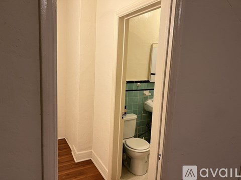 A bathroom with a toilet and a sink.