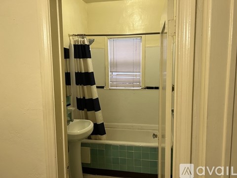 A bathroom with a striped shower curtain.