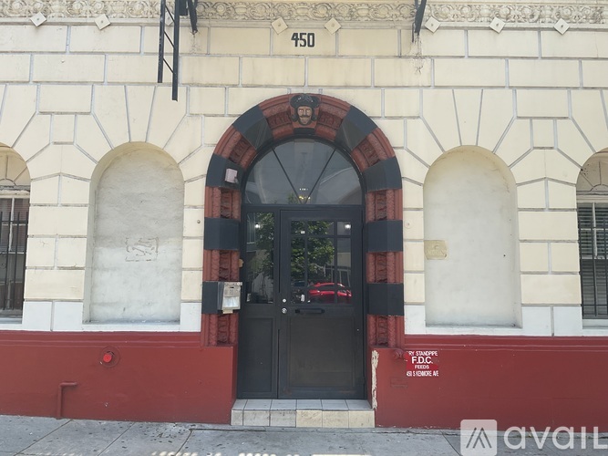 The building has a black door with a red frame.