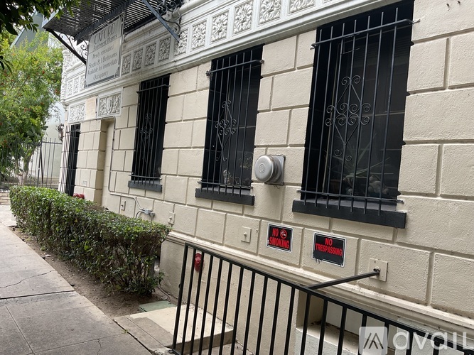 A building with a black iron fence and a sign that says "NO SMOKING".