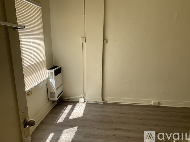 A room with a radiator and a wall-mounted heater.
