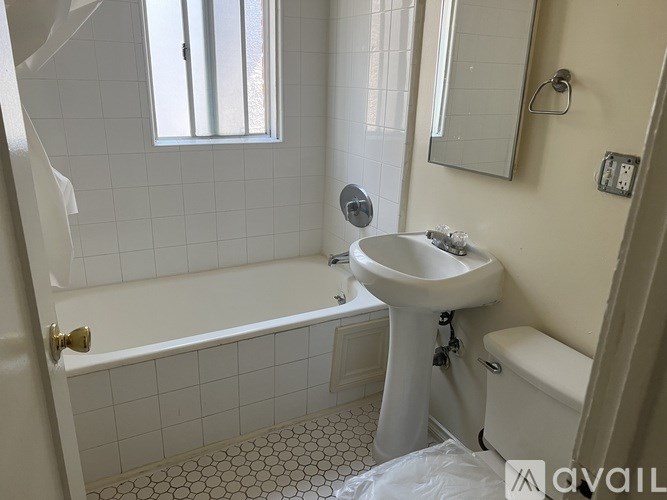 A white bathroom with a sink, toilet, and bathtub.