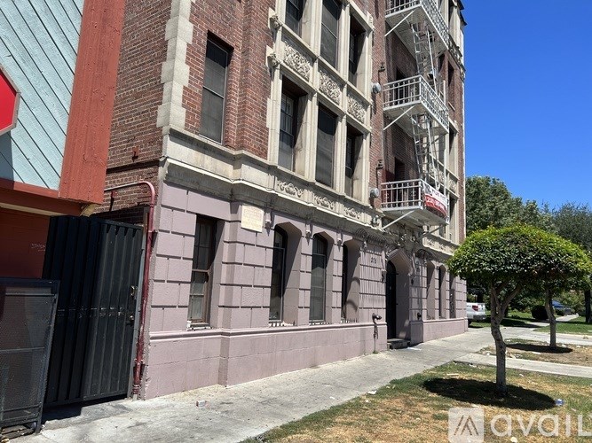 A tall building with a fire escape on the side.