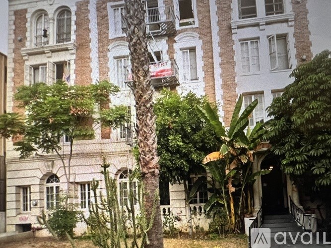 A building with a sign that says "AVAIL" in front of it.