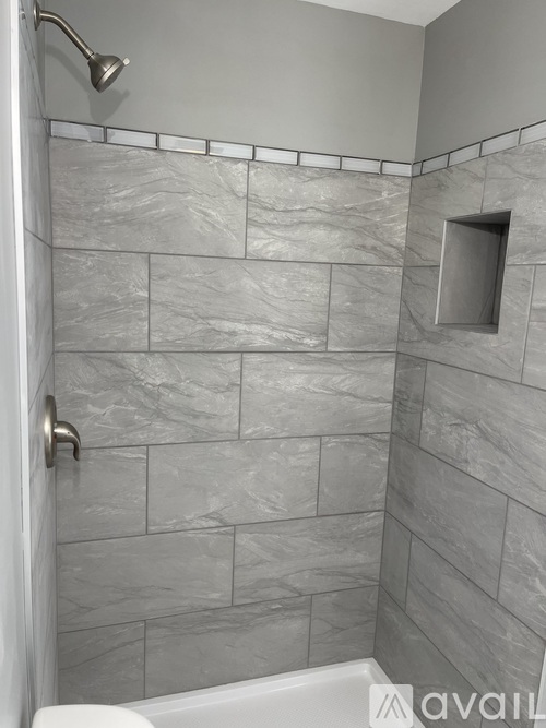 A bathroom with a shower and a tub.