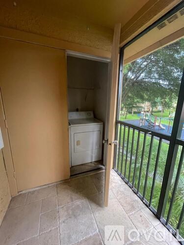 A small white refrigerator is in a kitchen with a door open.