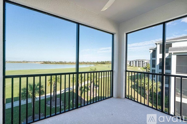 A balcony with a view of a body of water and buildings.