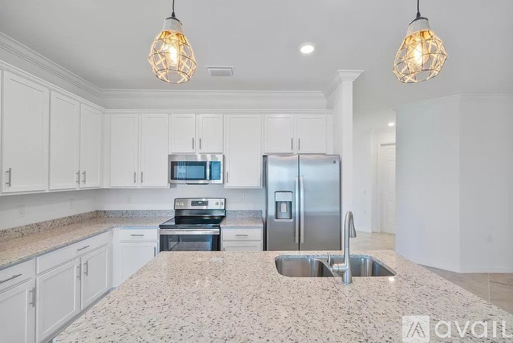 A kitchen with granite countertops and stainless steel appliances.