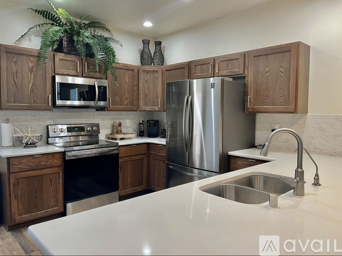 A kitchen with wooden cabinets and stainless steel appliances.