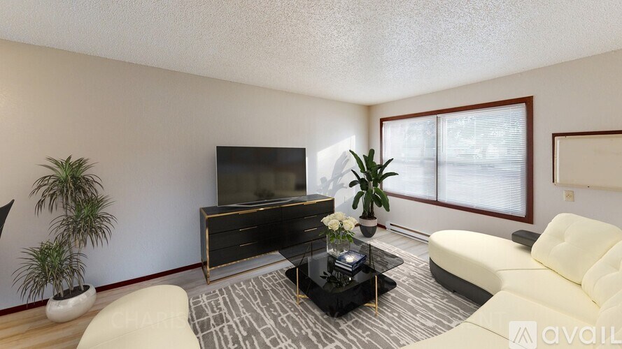 A living room with a television, two chairs, and a coffee table.