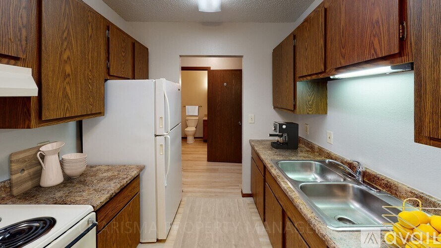 A kitchen with wooden cabinets and a white refrigerator.