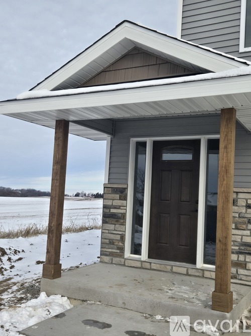 A house with a brown door and a porch.
