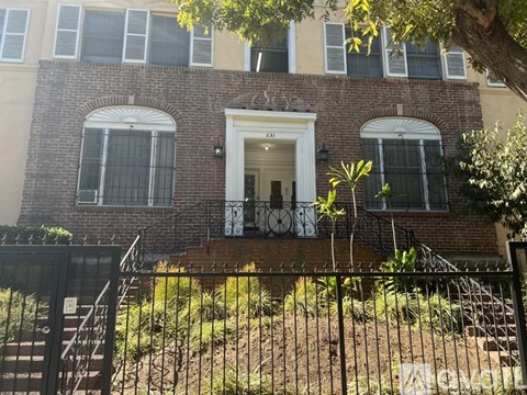 A brick building with a white door and windows.