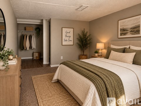 A spacious room with wooden floors and a ceiling fan.