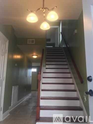 A staircase with a light on the side of it.